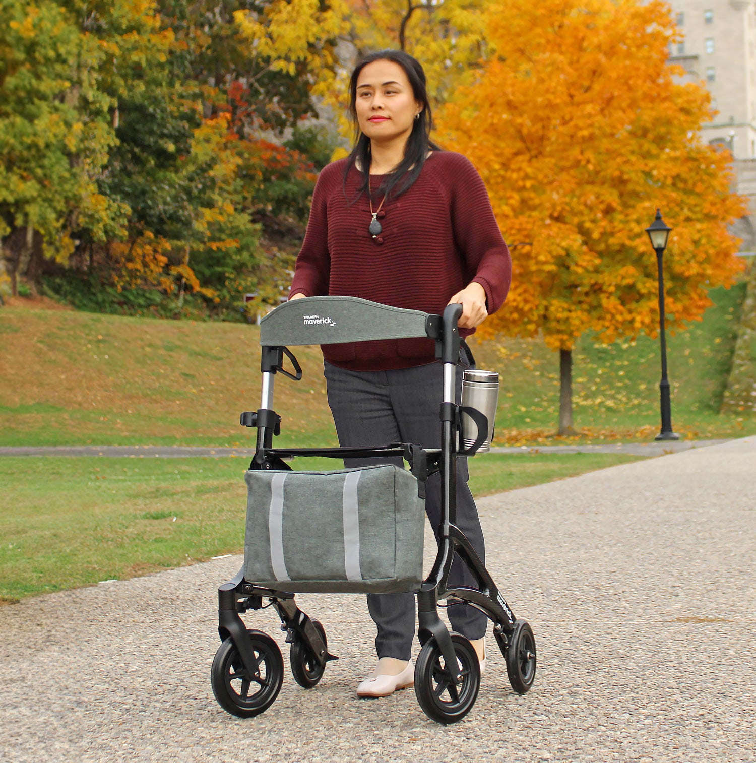 Maverick Carbon Fiber Black Rollator Walker in use on a path