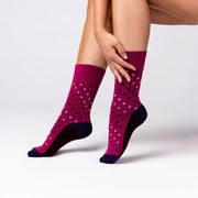 woman wearing pinjk polka dot non binding socks