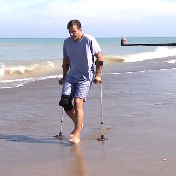 sand pad on crutches at beach